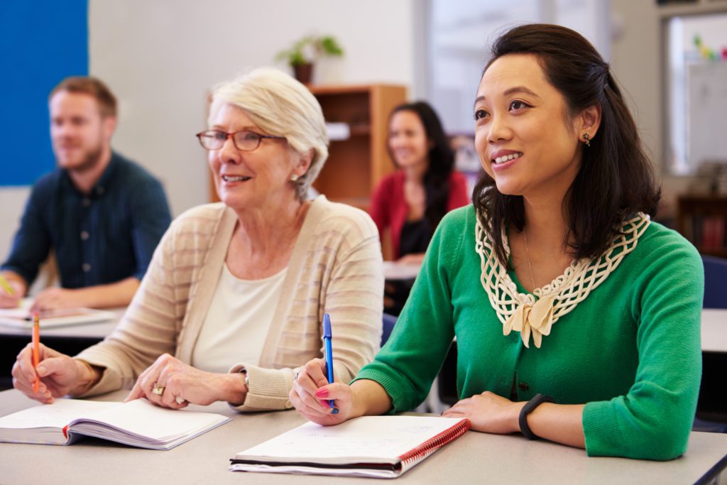 Two women taking a business education class